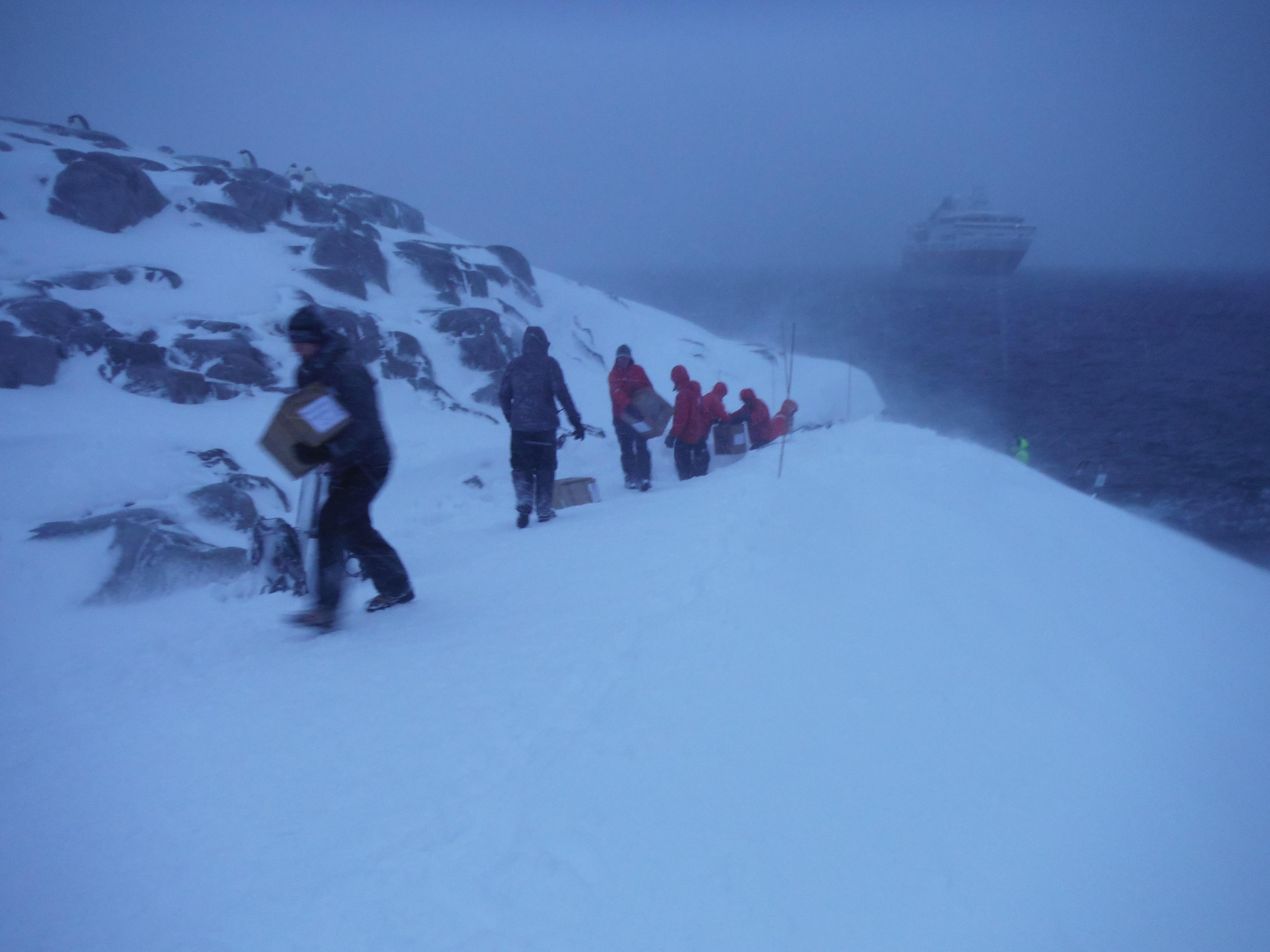 People unloading cargo in blizzard