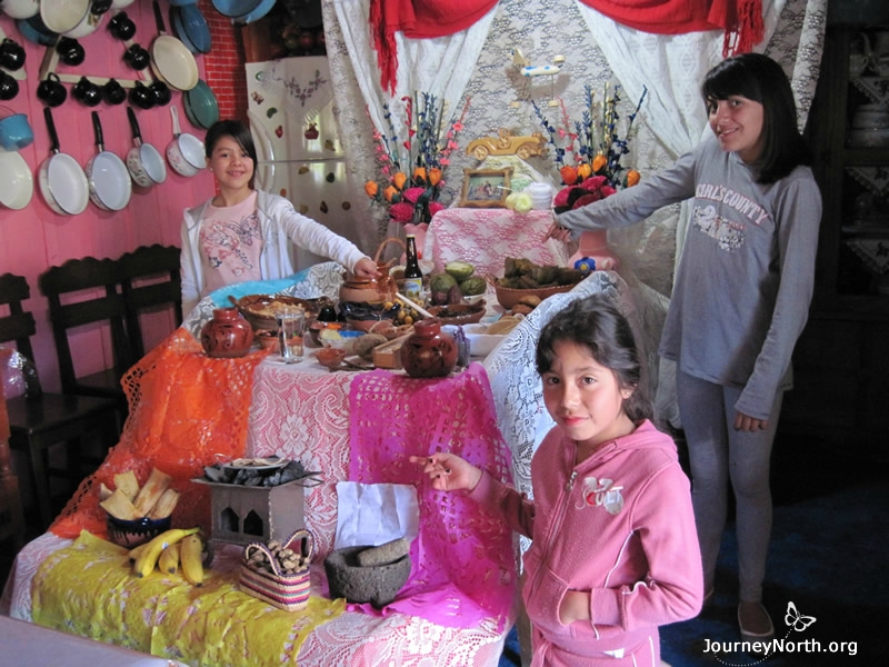 Families set up an ofrenda (shrine) to honor the memory of our deceased ancestors. Lupita invited Laura Emilia and Zamara to see her family's ofrenda.