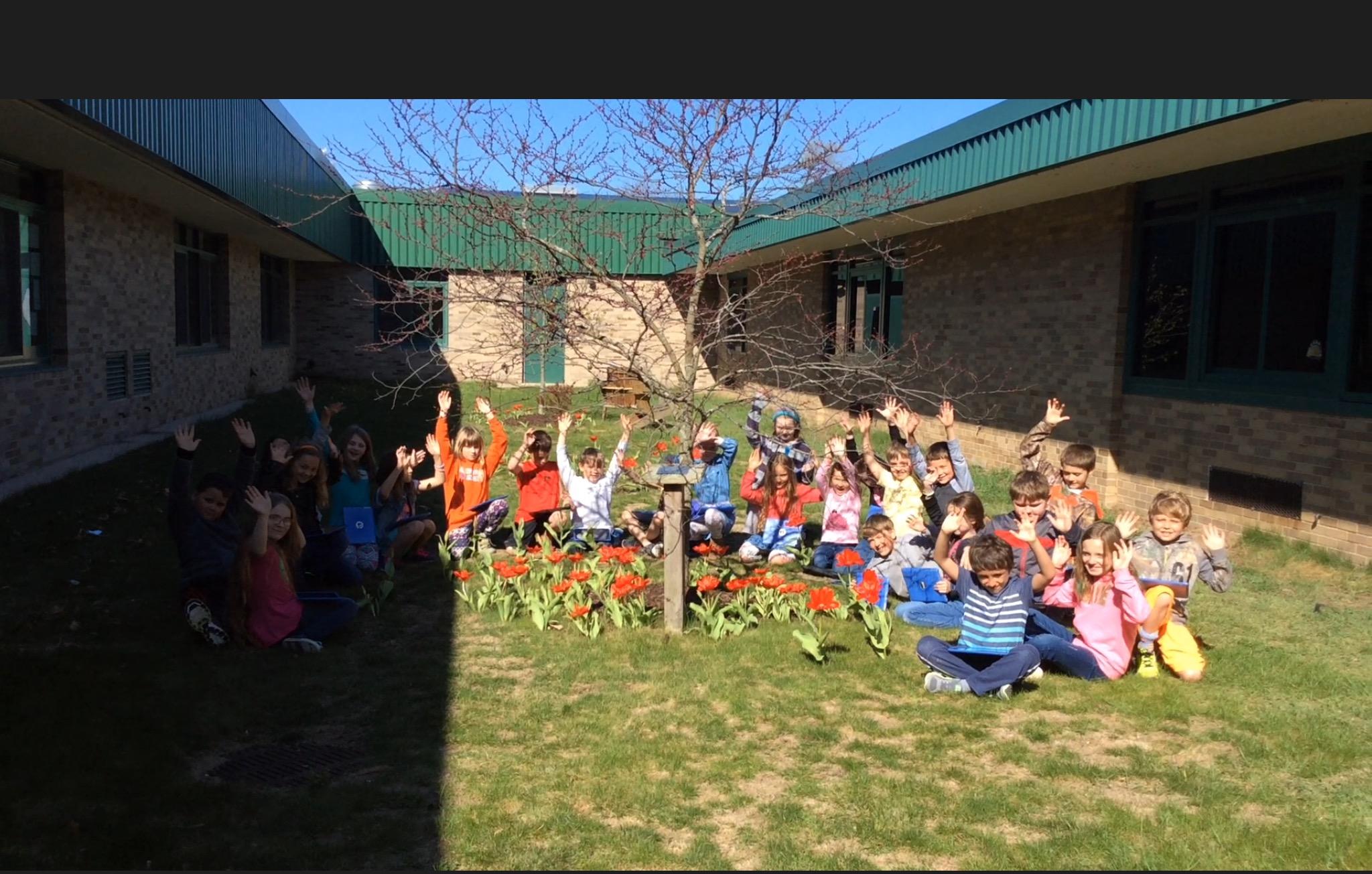 photo of students posing in their blooming garden