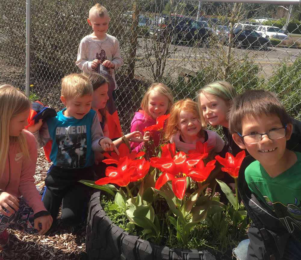 Kids in their blooming tulip garden