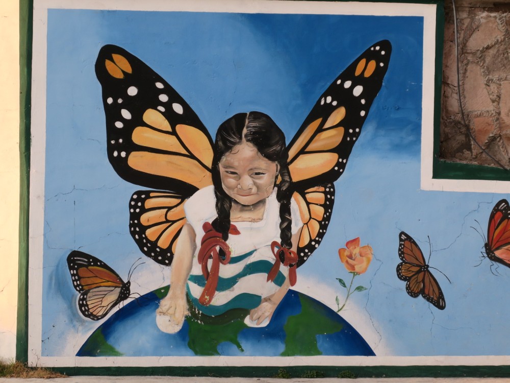 mural of young girl resurrected as a monarch