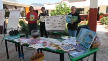 posters and books held by teachers