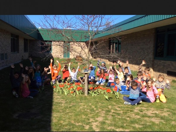 photo of students posing in their blooming garden
