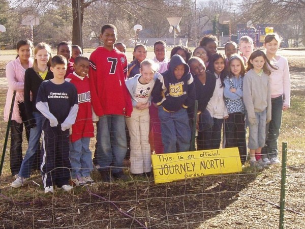 Photo of class in the garden with their sign