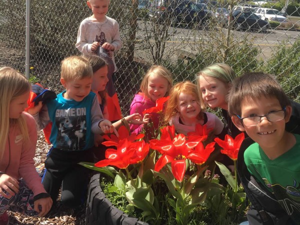 Kids in their blooming tulip garden