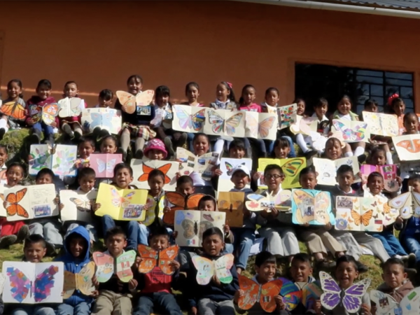 Students holding Ambassador Monarchs in Mexico