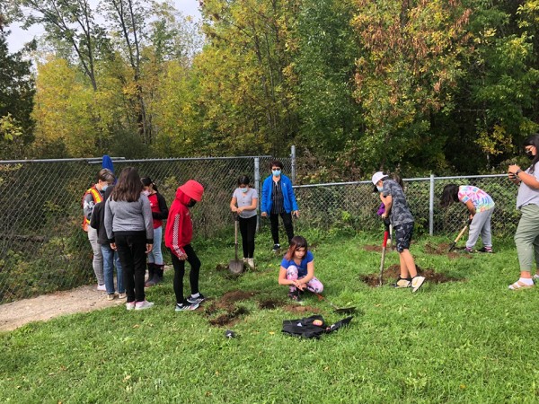 students planting milkweed