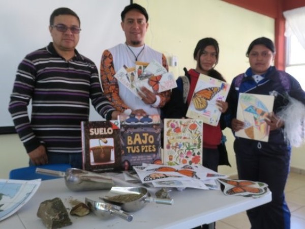 Four teachers hold donated books at Miguel Hidalgo Middle School in Mexico